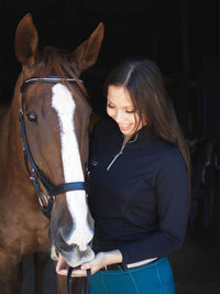 Woman with horse, Woman wearing summer long sleeve riding top in black and Plum Tack Juniper riding tights