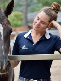 Woman patting horse wearing Plum Tack