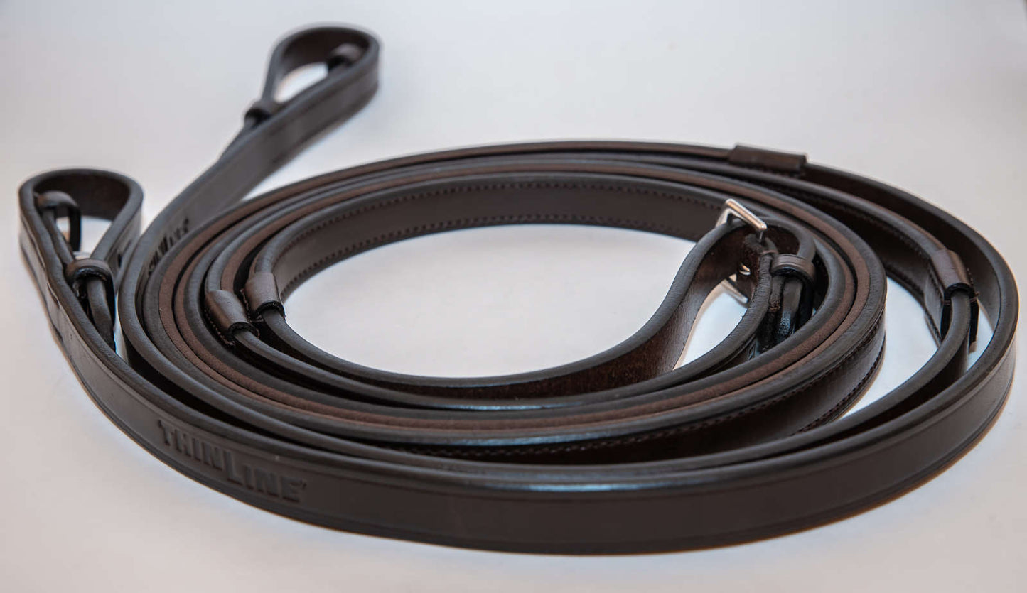 Coiled Thinline leather reins with attached metal buckle ends.